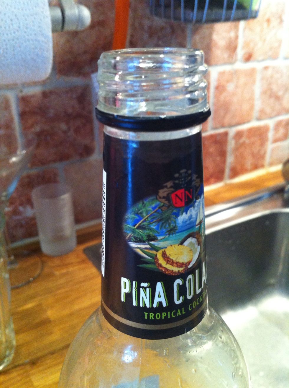 You need to take off the label and the ring. You simply cut off the metallicring with a knife or with a plier (if that's the name)