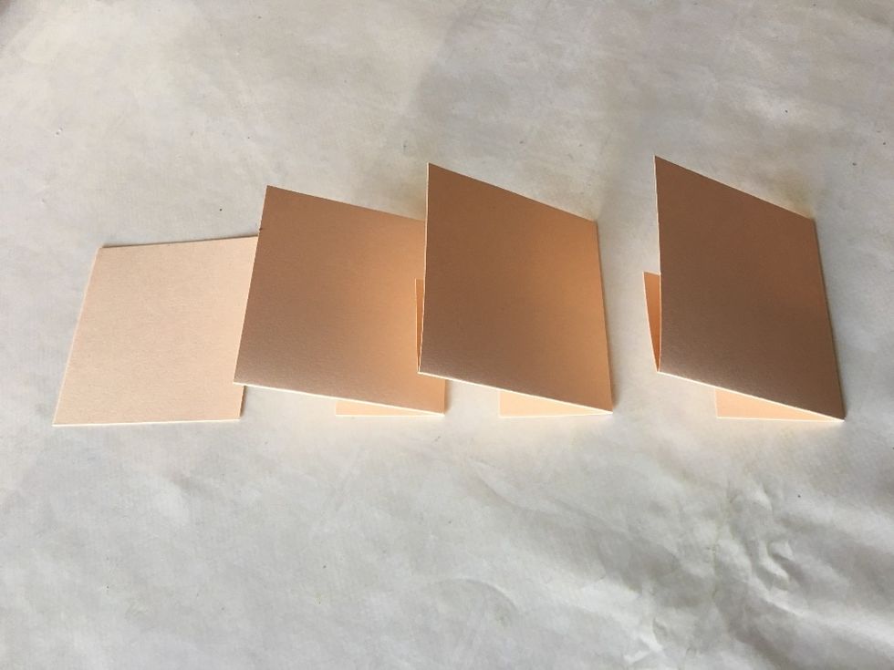 You now have what will be the front cover piece plus three pocket pages. Turn the three page pieces over so you\u2019re looking at their backs.