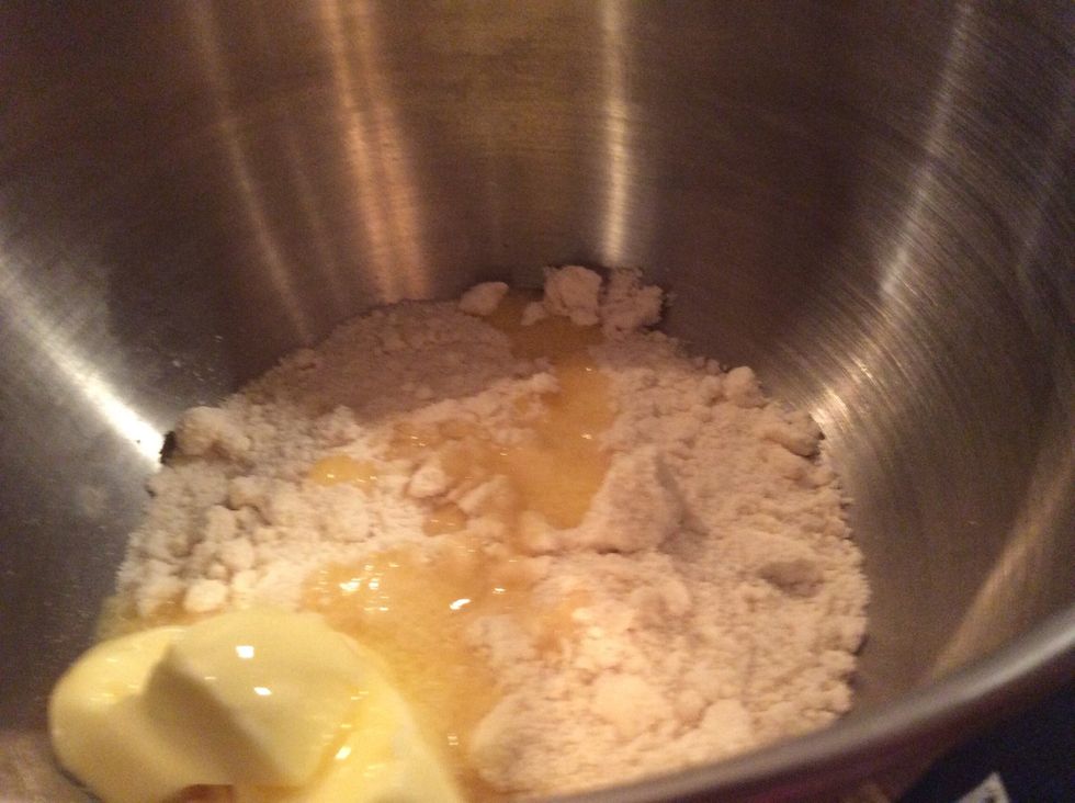 You pour the butter in the flour