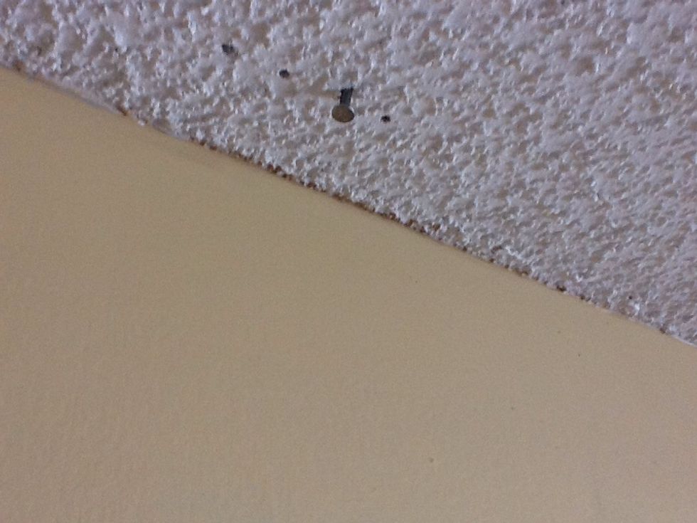 You should have a general idea of where they are located - generally, they are spaced 16 inches apart starting  from the wall. Locate them by nailing into the ceiling. You will locate them eventually.