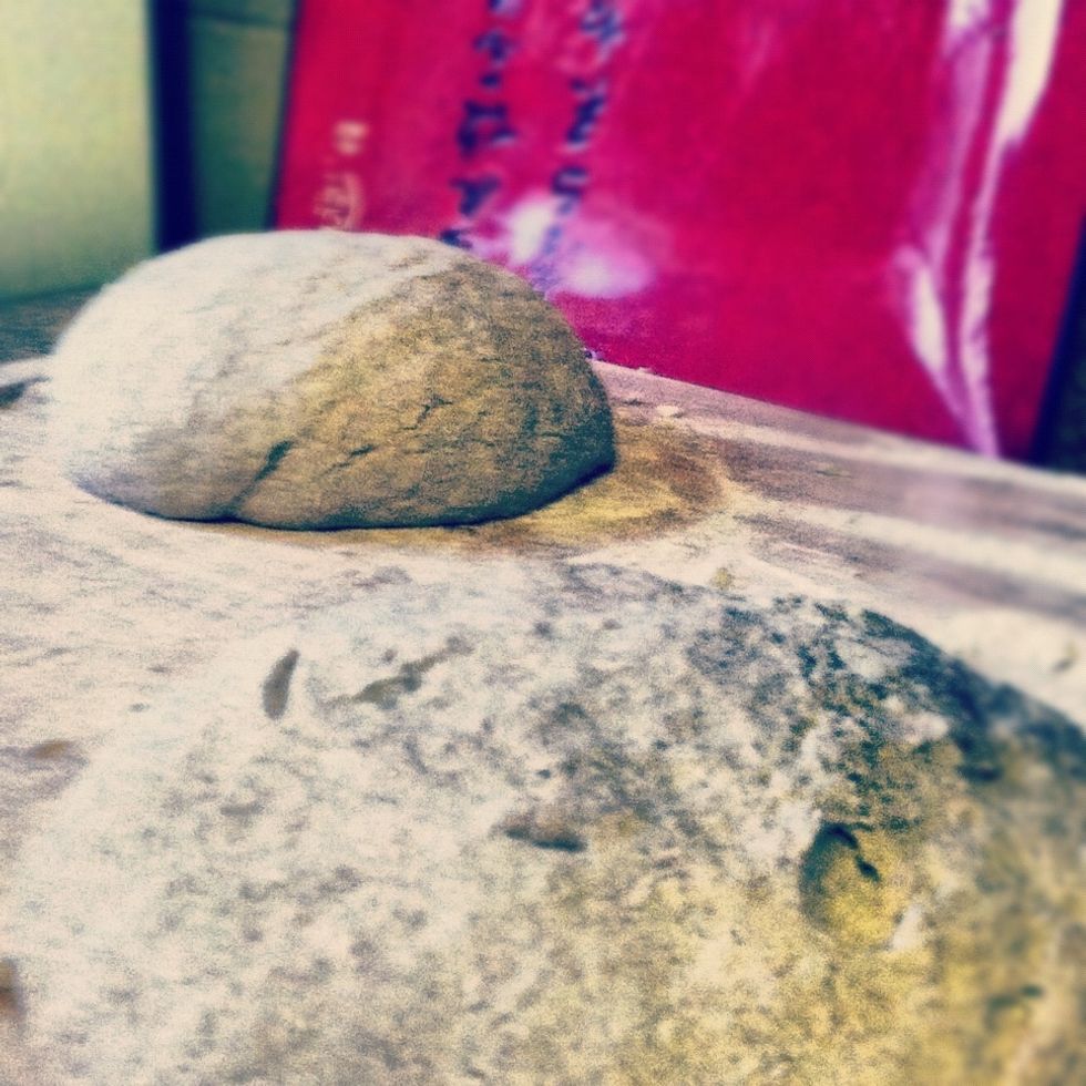 You should have enough dough for two loaves. Break the dough in two and make tightly formed balls of dough