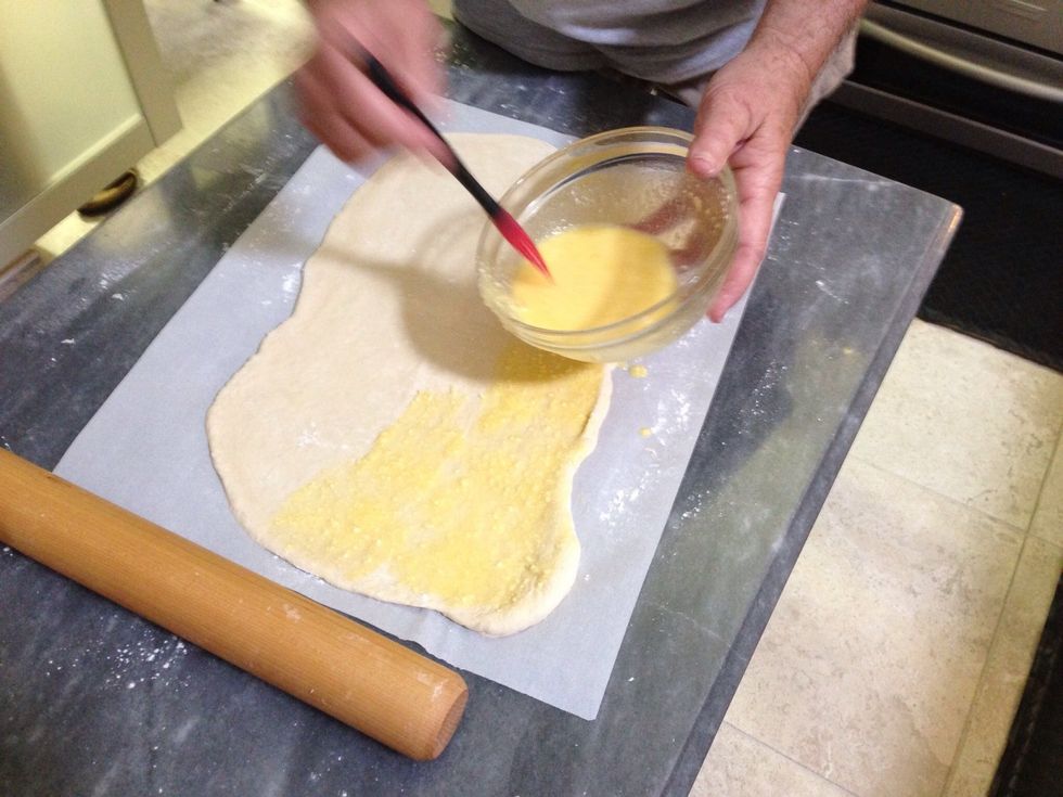 You should have more than enough to cover the dough, but save a little for the outside of the crust.