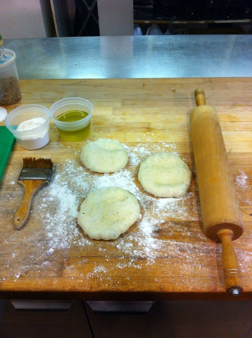 You should have your rolling pin out some flour for dusting and olive oil for brushing. Also a baking sheet and several parchment papers.