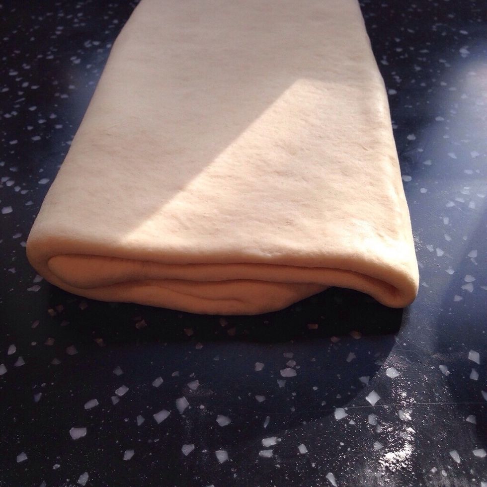 You should now clearly see the start of the layers in the dough. Repeat the rolling and folding two more times. Each time ending with a 20x60cm rectangle. Wrap in cling film and refrigerate over night