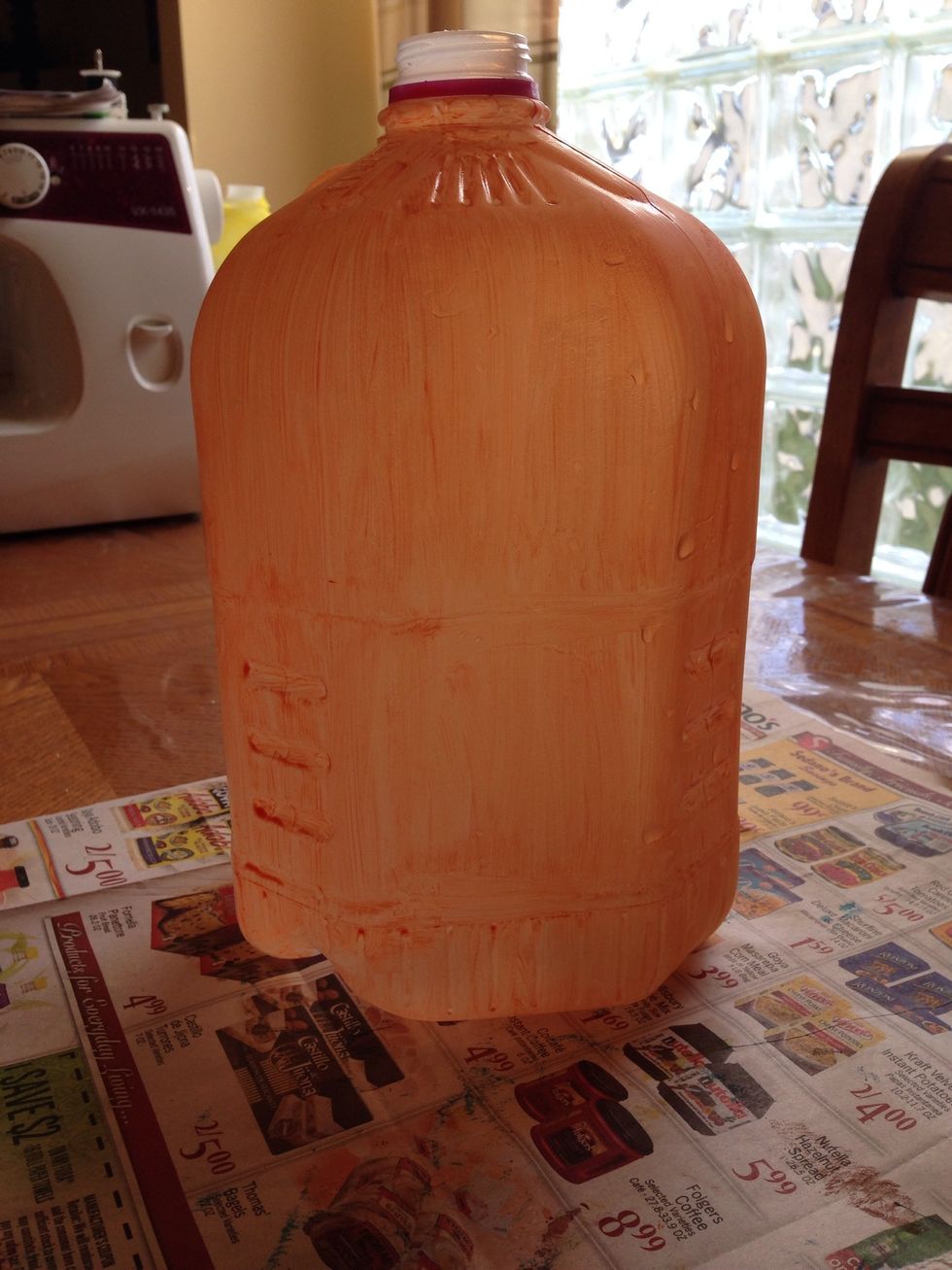 You should now have a nice light colored orange jug. You don't want to put the paint on to thick or the string lights won't show through. Let it sit and dry for a while.