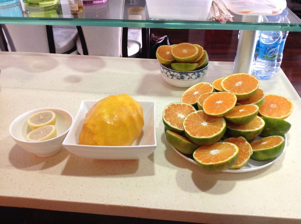 You should now have your three fruit prepared to make the orange juice.