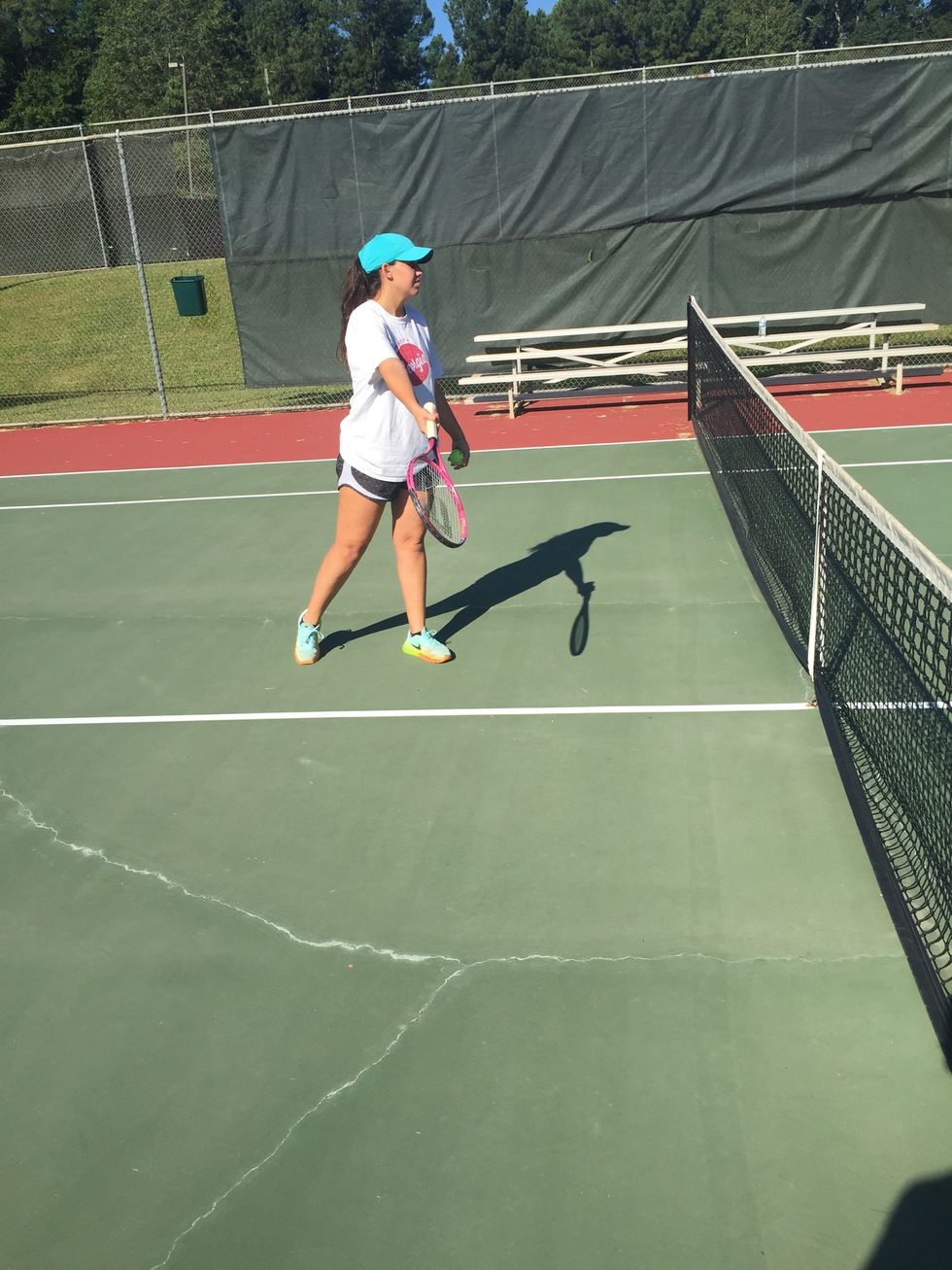 You should then transfer your weight from your back foot to the front foot while following through with your racquet and your racquet should make contact with the ball in front ball should not bounce