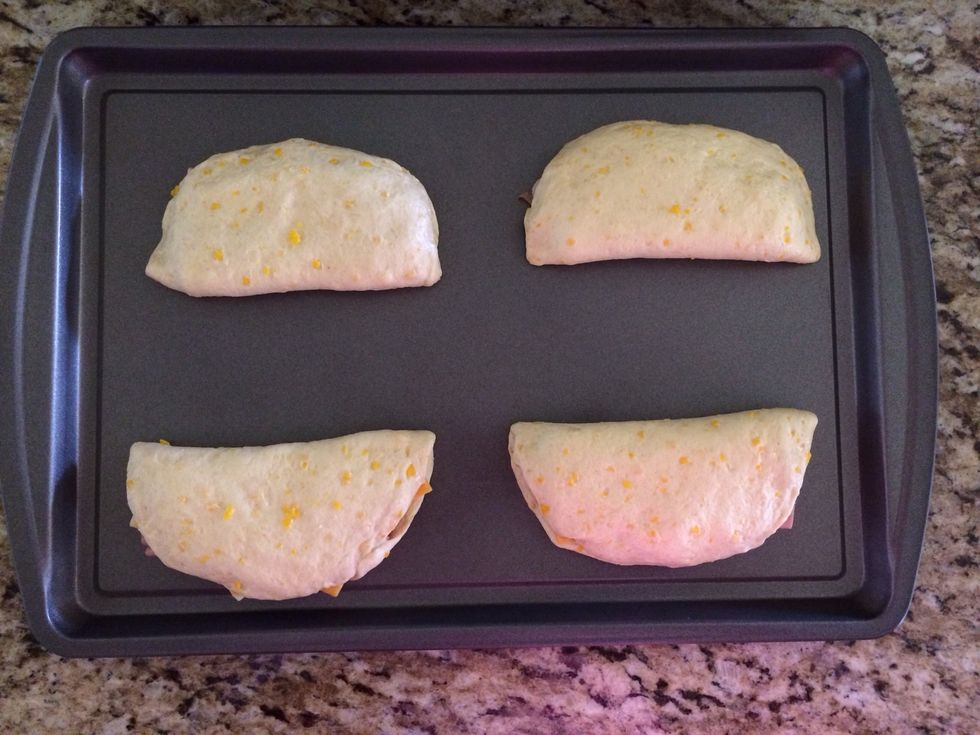 You take the round biscuit and flatten it. Here I did the half moon shape and filled it with my cheese and ham. This was the more messy version. Feel free to add jalape\u00f1os, peppers, onions...up to u