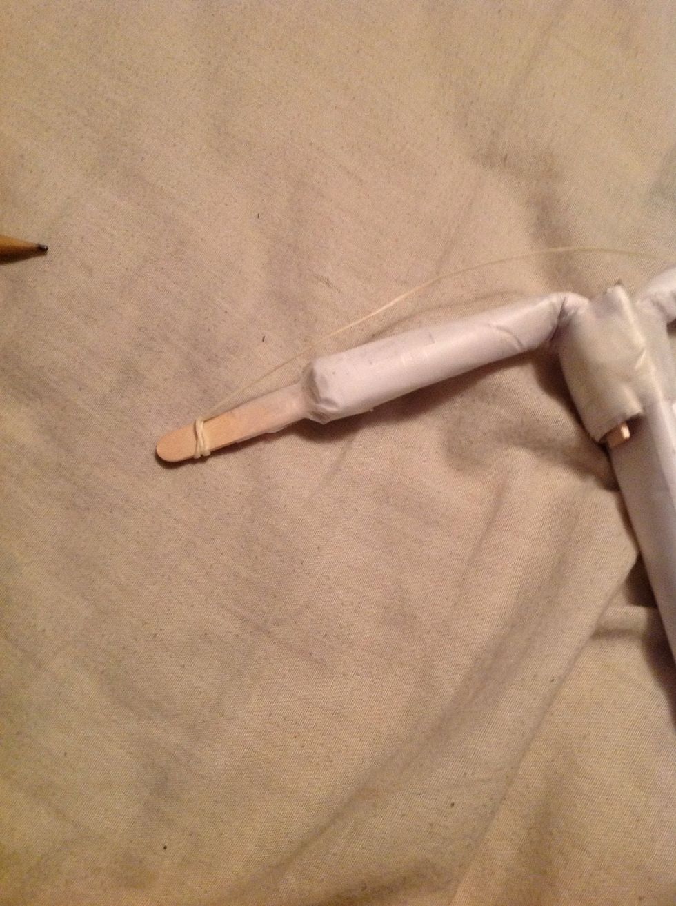 You then need to grab some twine or really strong string and tie you around the end of the popsicle stick.
