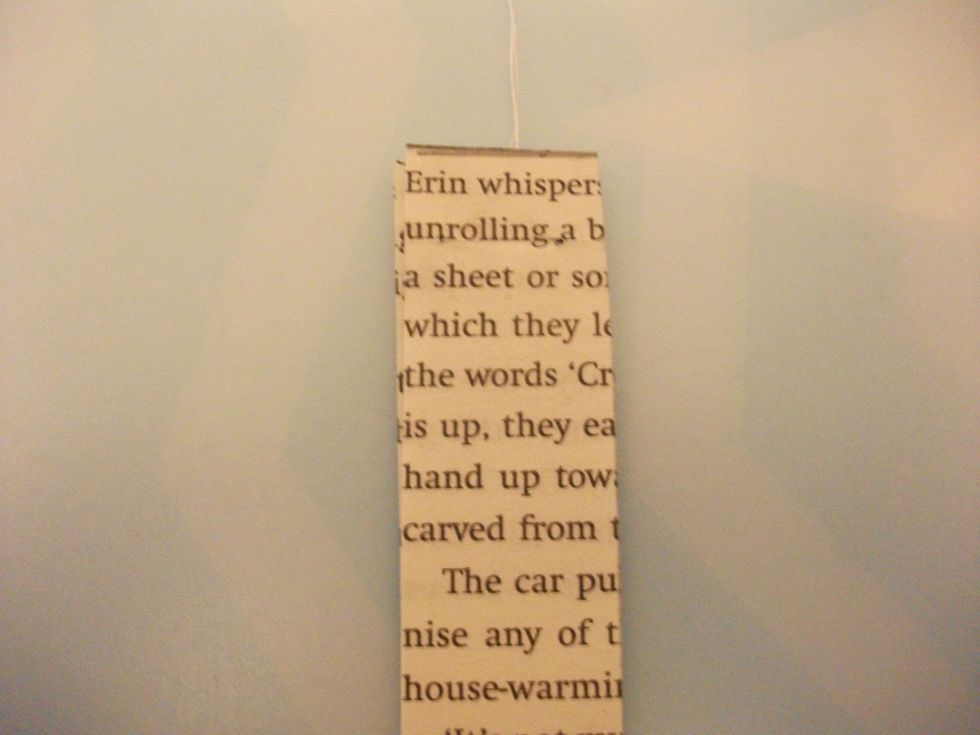 You then take the other long strip and 'sandwich' it onto the first, make sure that the thread remains in place.