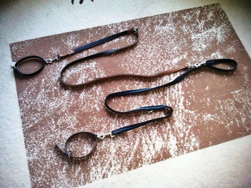 You use one hand strap and connect the second leash to it.