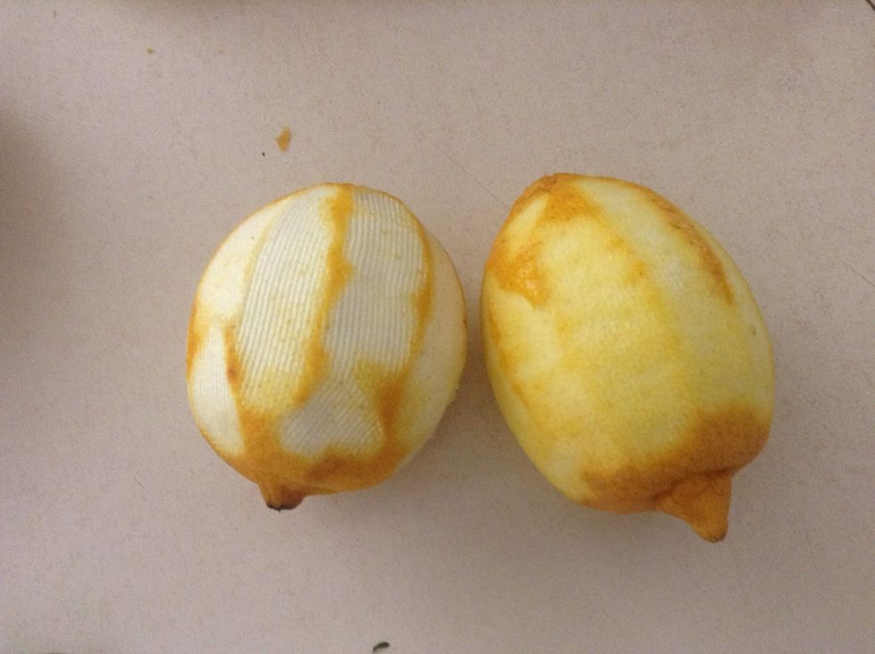 You want only the yellow layer of the lemon skin. Good example lemon on right - has not cut into the white, bad example on the left - too much white has been taken.