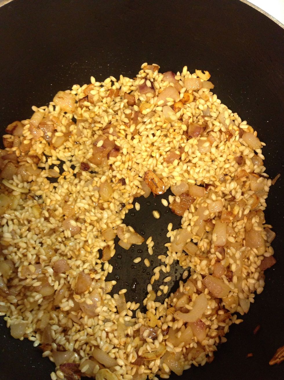 You want the arborio to toast and become tan, like so.