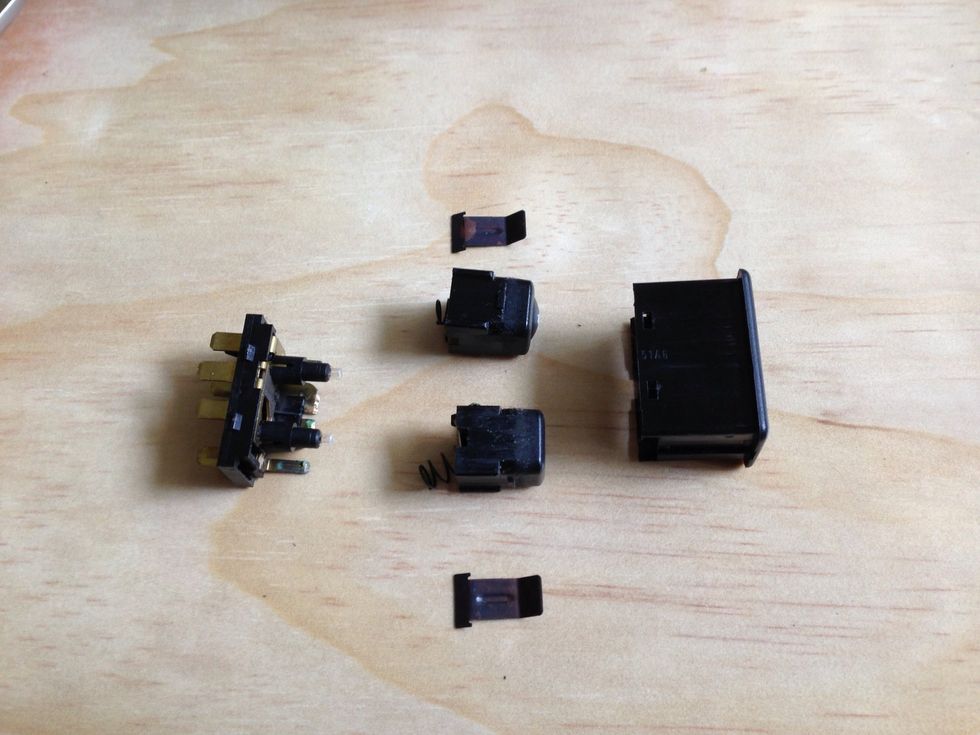 You want to put the screw between the casing and the actual switch itself. Work your way around until it pops open. Be aware of flying parts. It's spring loaded! Here they are laid out