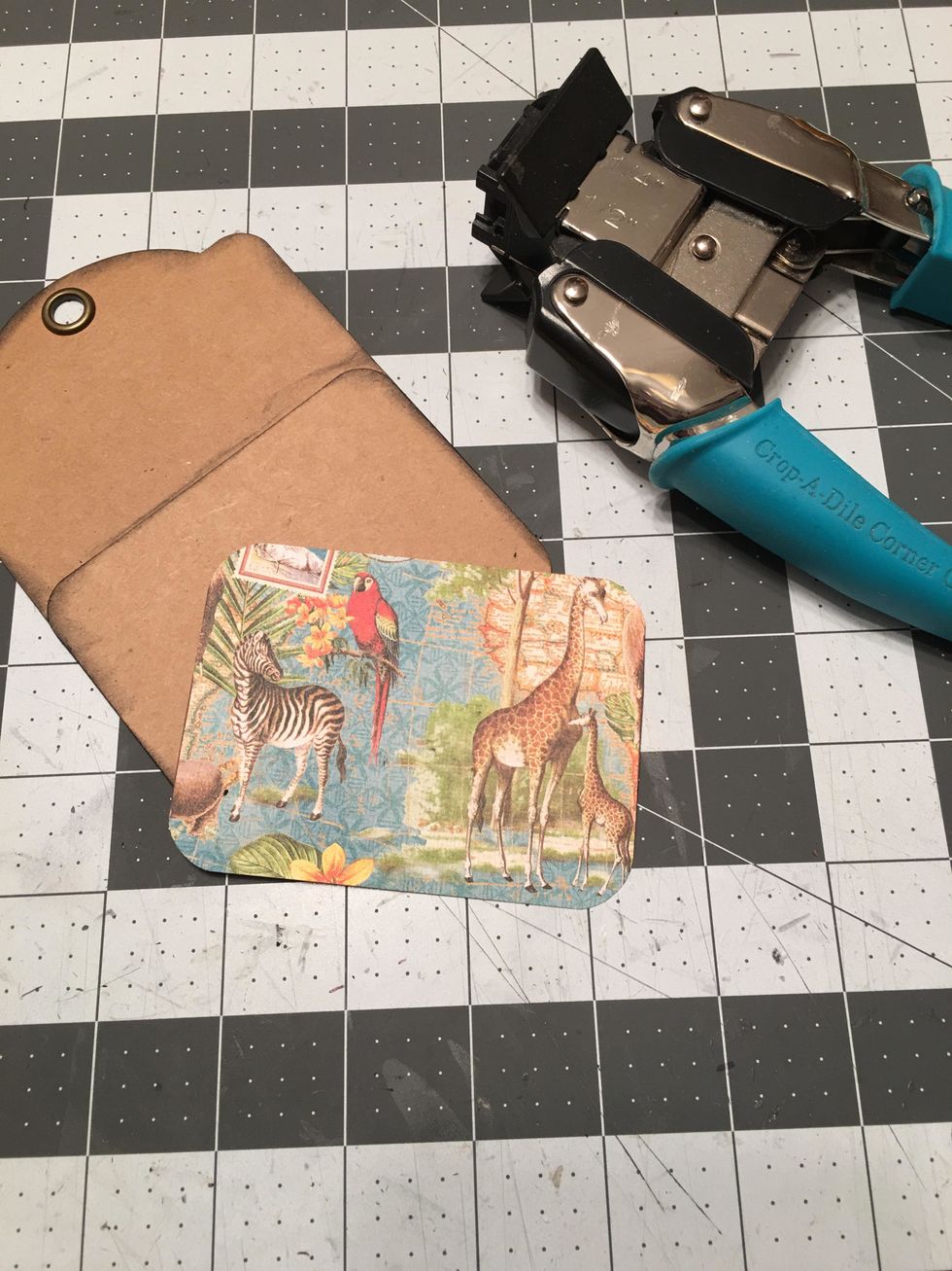 You will also need to punch the top two corners of the patterned paper with the 1/2 inch punch to make them match the pocket edges.