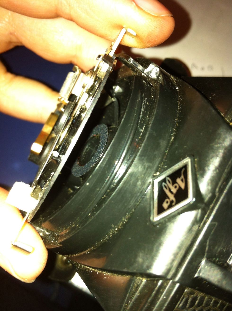 You will be able to lift off this plate. You see the black plastic hole? this is where you glue your pinhole plate. Make sure it is centred and super glue (or tape if you wish to leave the option open