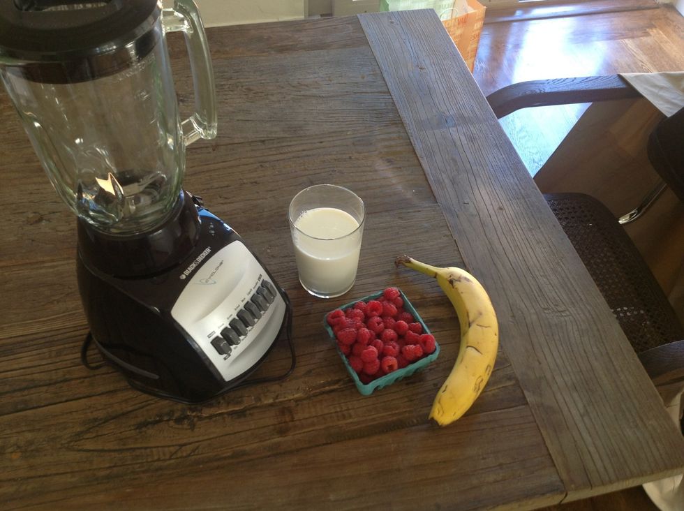 You will first need a blender, banana, a glass of milk, raspberries and ice to make a great SMOOTHIE!!