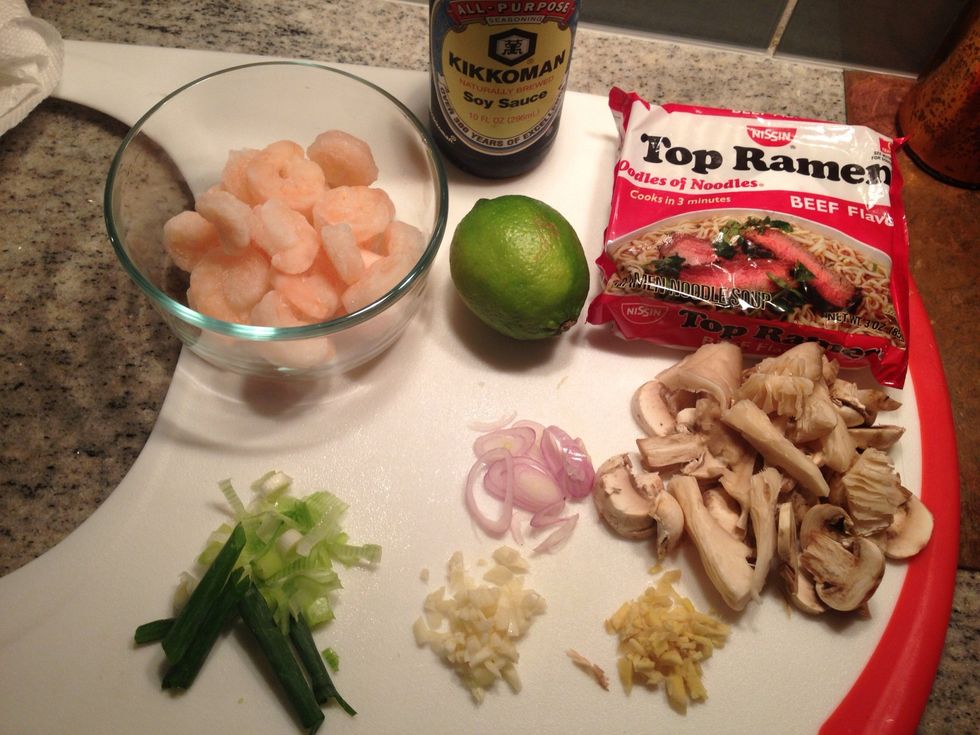 You will need: 1 package of Ramen Noodles, soy sauce, lime juice (1/2 lime), shrimp (in my case frozen cooked shrimp), assortment of mushrooms, and roughly chopped garlic, ginger, and green onions