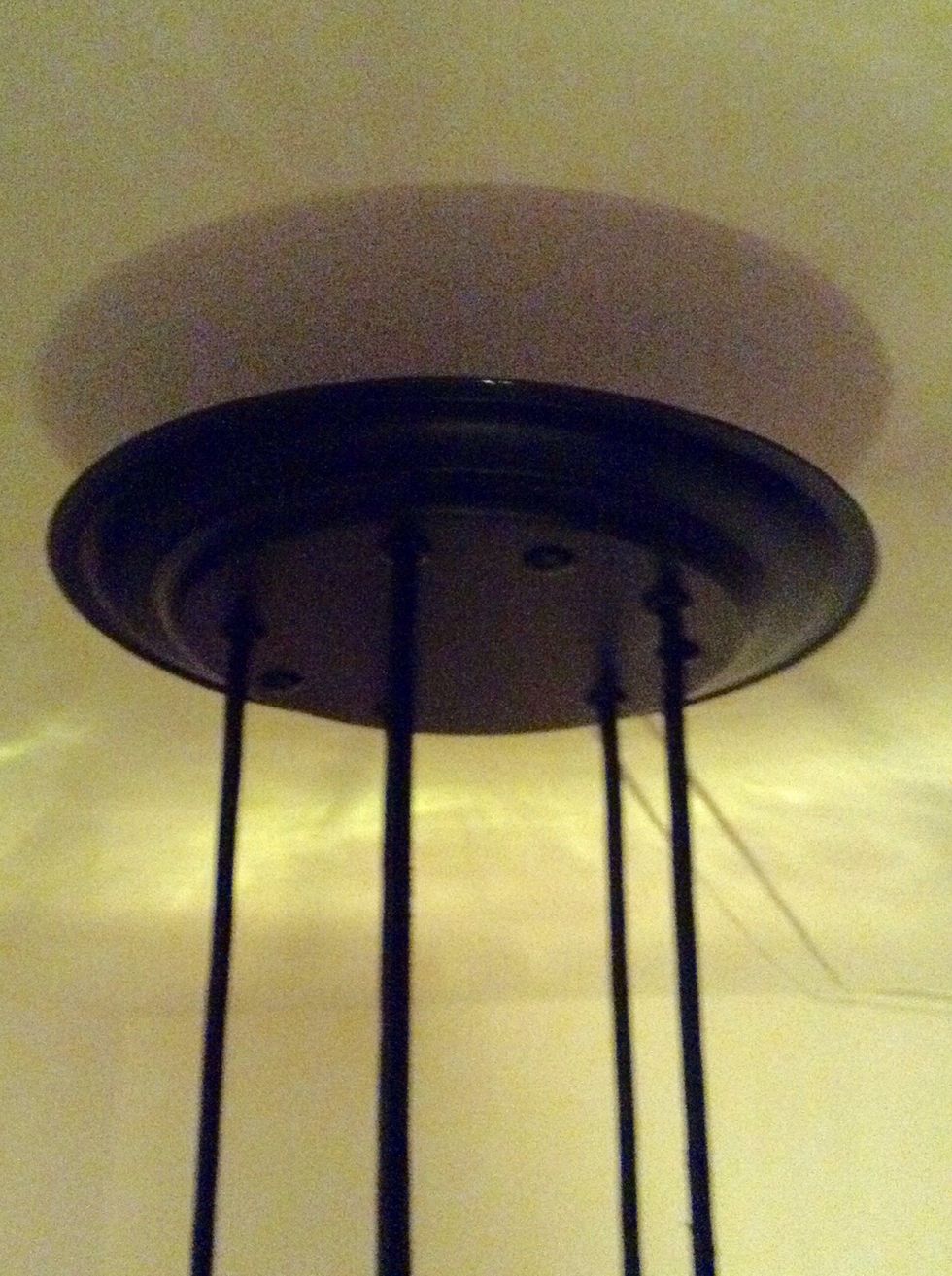 You will need a base for the lamp. I used an old metal dish, spray painted it, drilled five holes in it for the cords and three for the bolts