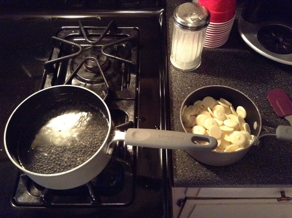 You will need a large pot and a small pot. Boil water in the large pot and pour the vanilla candy melts into the small pot.
