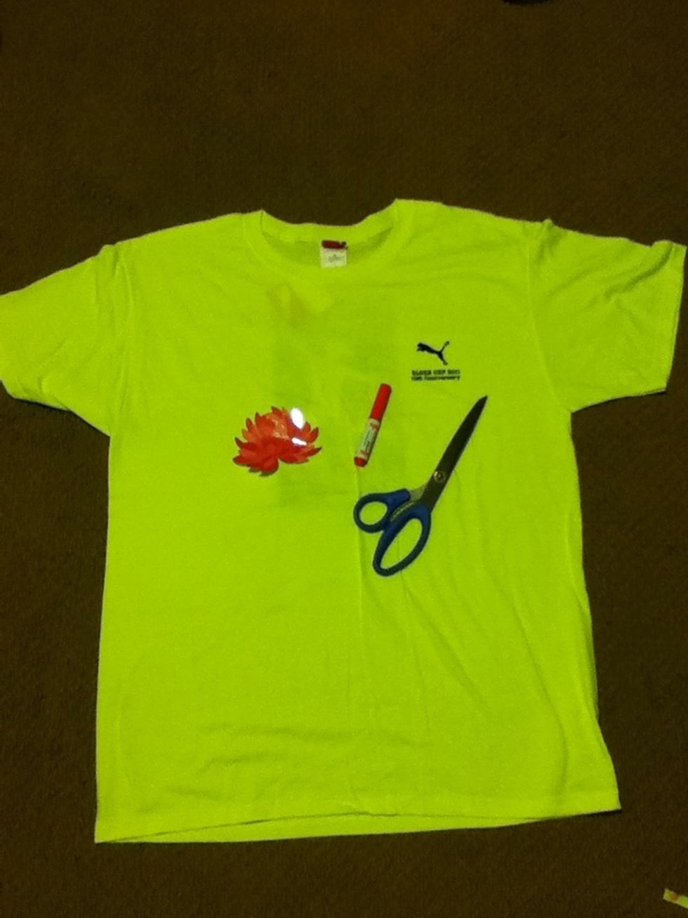 You will need: A large T-shirt A pair of fabric scissors(you can use regular scissors but I think fabric scissors are easier to use) And a piece of paper of something flat