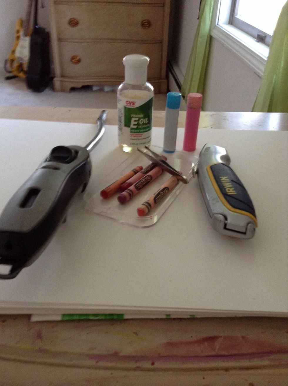 You will need a lighter, crayons, an exacta knife( optional) , a small container, something to put the balm in ( I am using old chap stick tubes) ,a small bowl, and e oil.