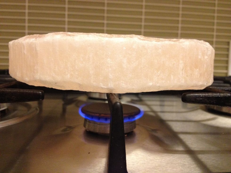 You will need a salt block of at least 1 inch thick, preferably 1.5 inches thick. To start your cooking, place your salt block on a gas burner over LOW heat.