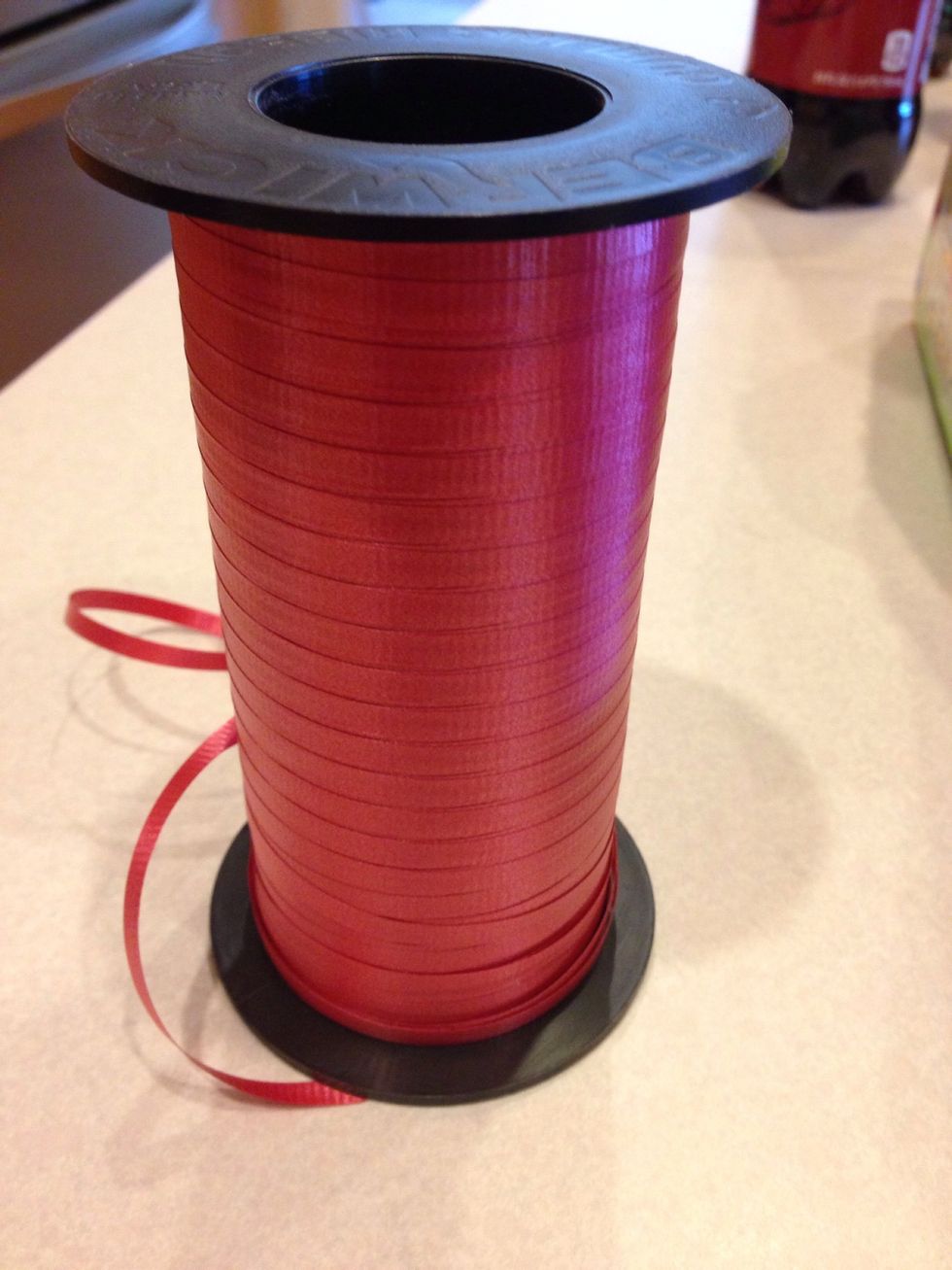 You will need curling ribbon to secure the candy to the bottles.