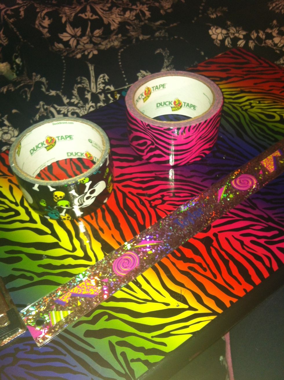 You will need Duck Tape (obviously) the color is your choice! You will also need a ruler and a flat surface to work on. Here I have black scull and cross bone duck tape & pink zebra!