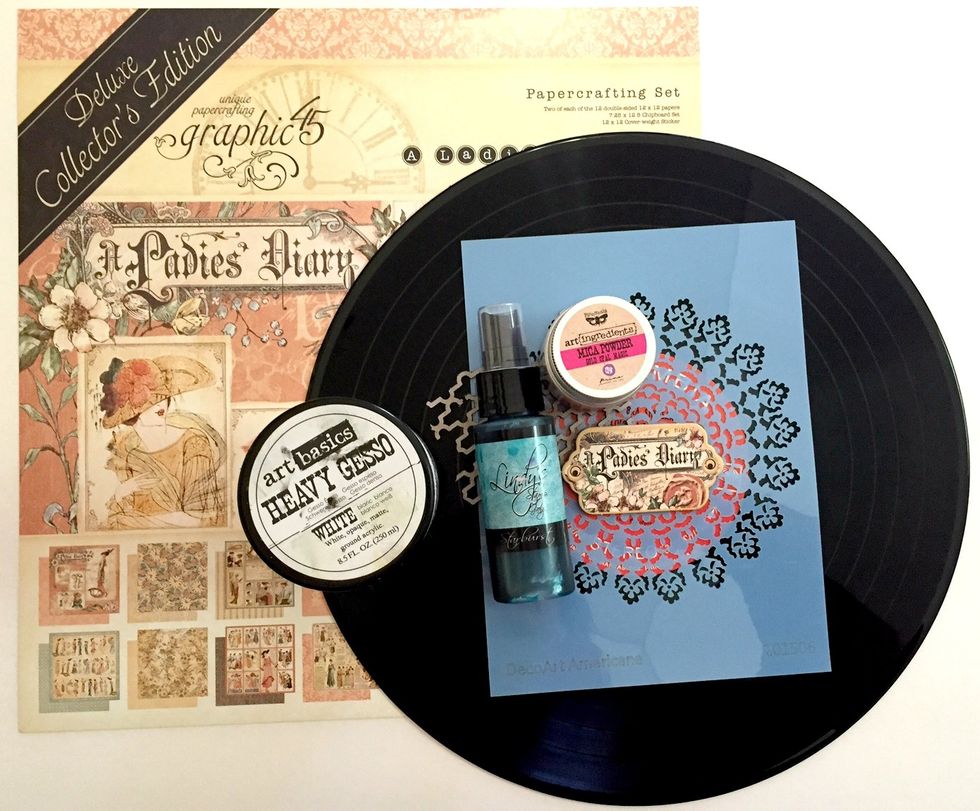 You will need "Ladies Diary" Deluxe Collector's Edition, Heavy Gesso, Doily Stencil, Spray Mist, Mica Powder (if you like) Chipboards and one 12" Vinyl Disc!