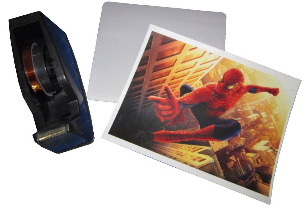 You will need printed transfer paper, a blank mousepad, heat transfer tape to position the transfer, and a heat press to begin.