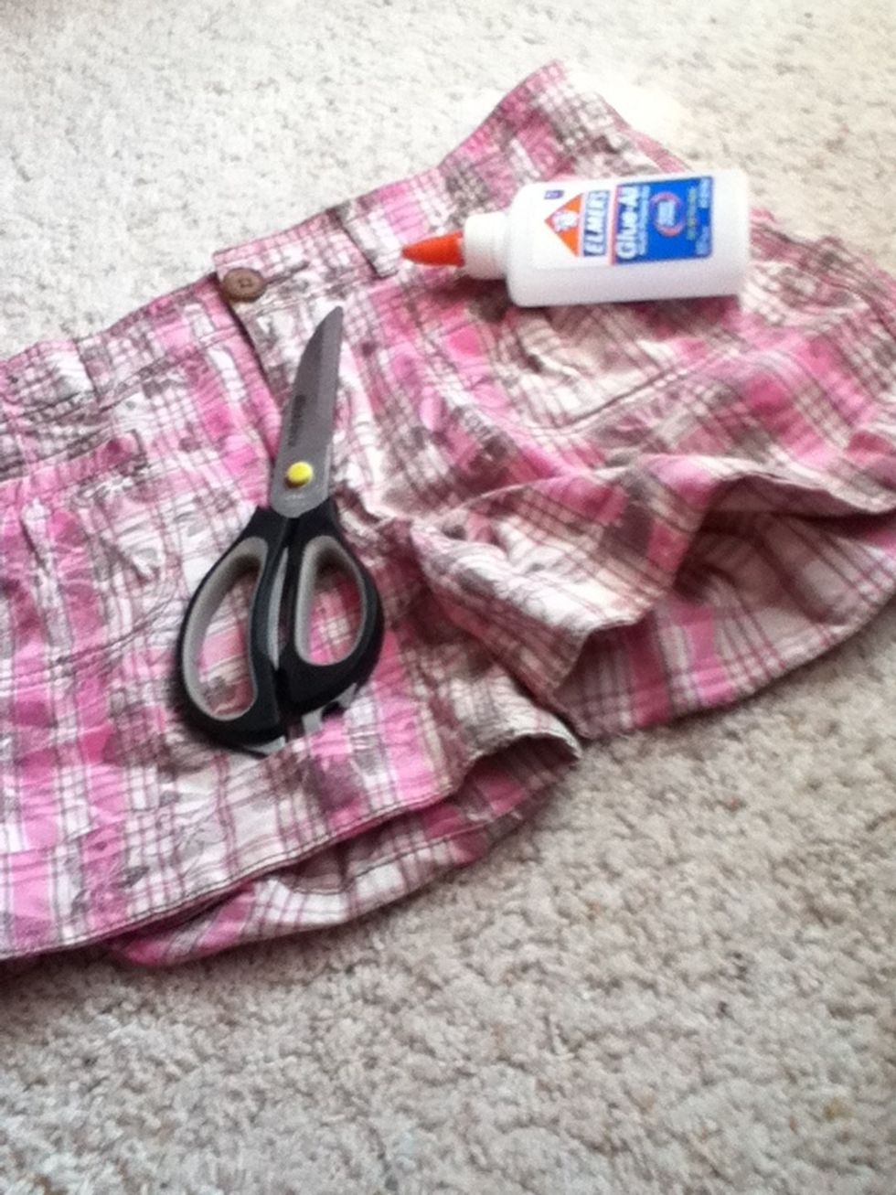 You will need scissors, glue, and an old pair of jeans or shorts
