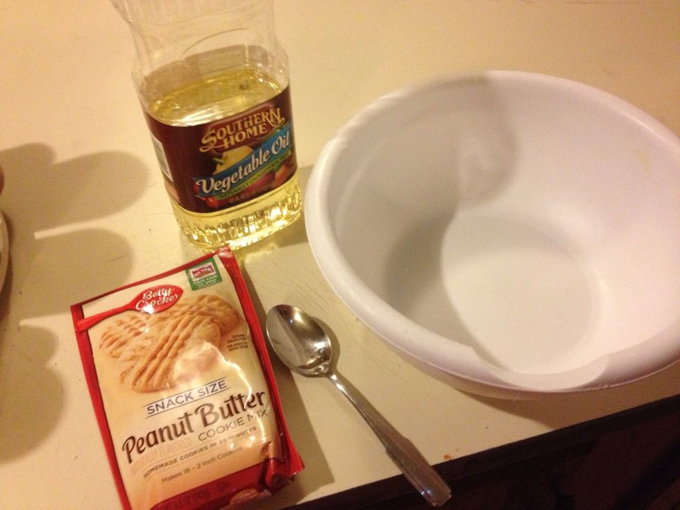 You will need snack size peanut butter cookie mix, vegetable oil, a medium sized bowl, a table spoon, water, a fork, a cookie pan, and non-stick spray (optional).