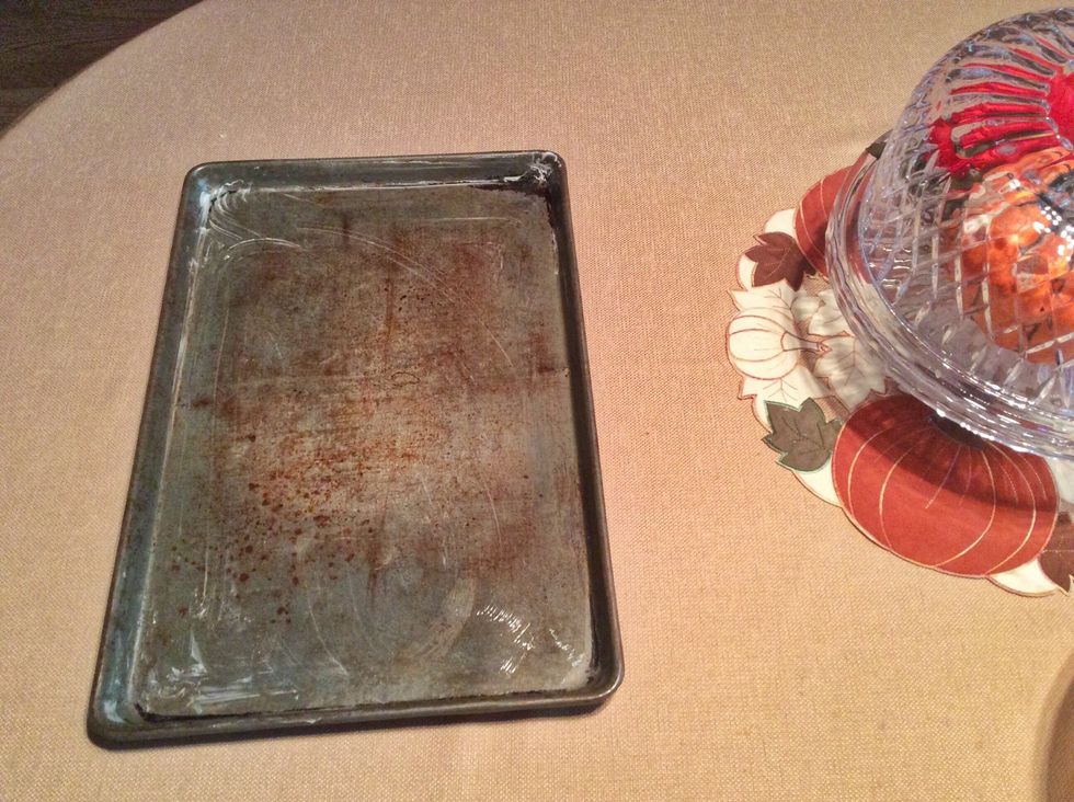 You will need to do this step more than once, but now grease a cookie sheet.