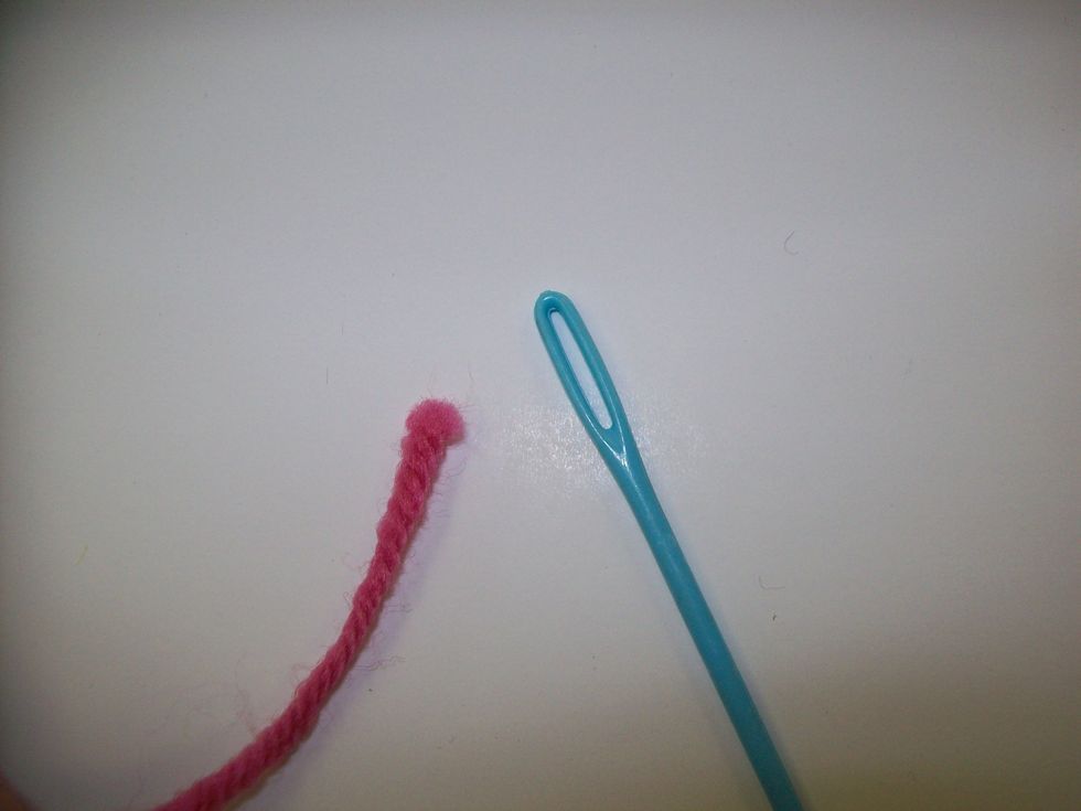 You will need to thread the other end of the weft through the eye of your plastic needle. If the end is frayed, you can bend the end of the yarn over and stuff the bend through.