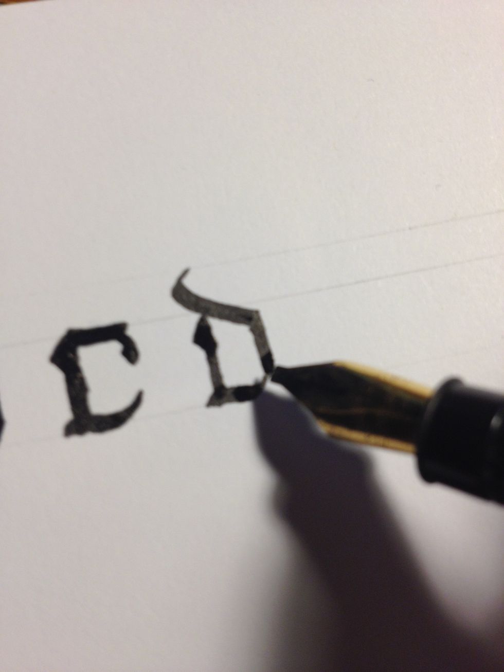 You will notice I have drawn two top lines, about half the distance as between the top and bottom line. Start from the second top line and make a flourished downward diagonal ending as a trunk.