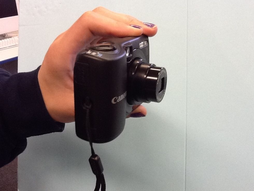 You will notice the lens pop out to take a picture.