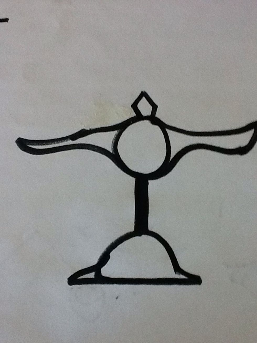 You will now draw the shaft of the balance scale. This shaft is also known as justice. The base should be wide and flat.