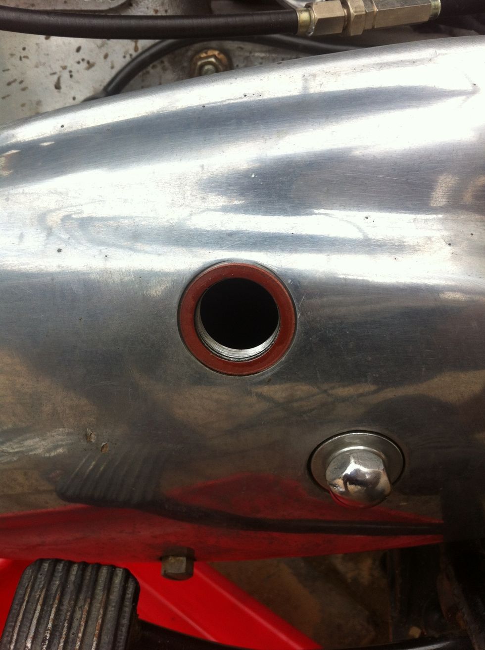 You will now have access to primary chain, insert a rod or screw driver to lift the primary chain to check tension.( Note do not put your finger in if the engine is running )