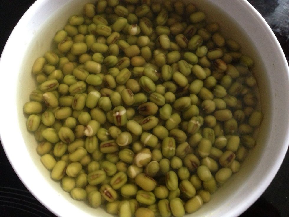 You will see them cracked open in the morning. Remove water and place the soybeans in the milk carton. Milk carton let the soybeans grow in the dark and help keeping the temperature.