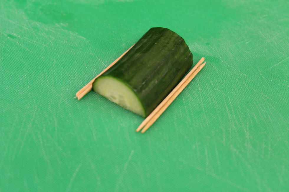 You will then need to cut the cucumber in half and place 3 tooth picks on both sides of it.