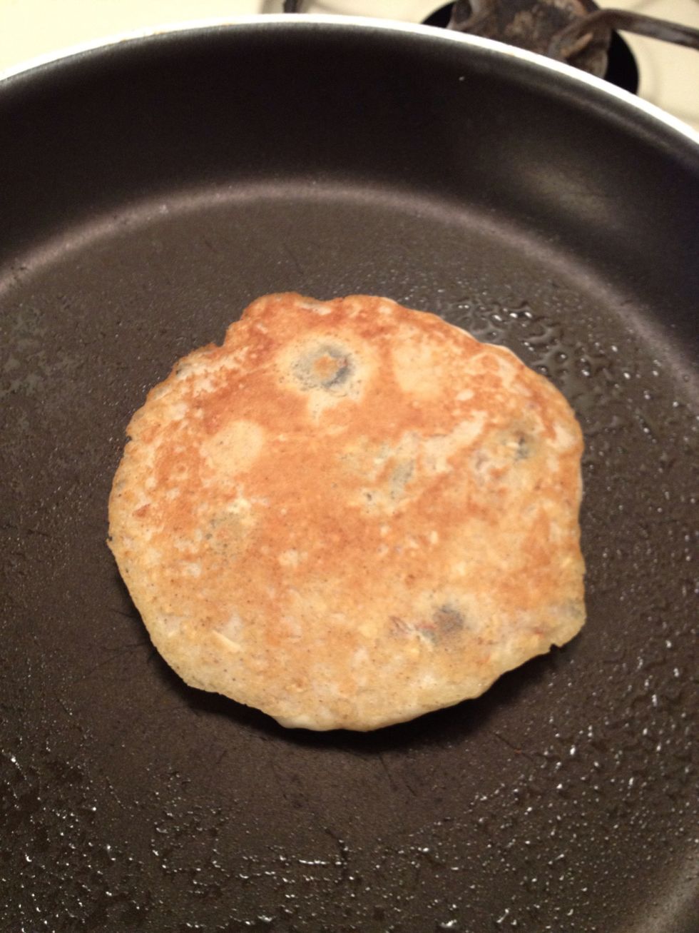 You won't see the design on the other side most of the time. Pressing down on the fruit just prevents it from flying out of the pancake when flipping over. May take some practice.