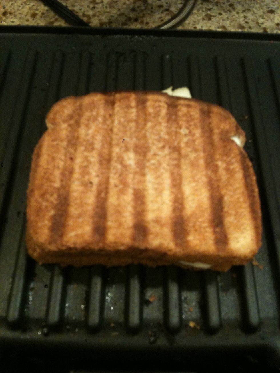 Your bread should look nice and toasted, it should feel slightly hardened if you tap it with your finger. Also look for the *now melted* cheese that you should be able to see coming out the side a bit