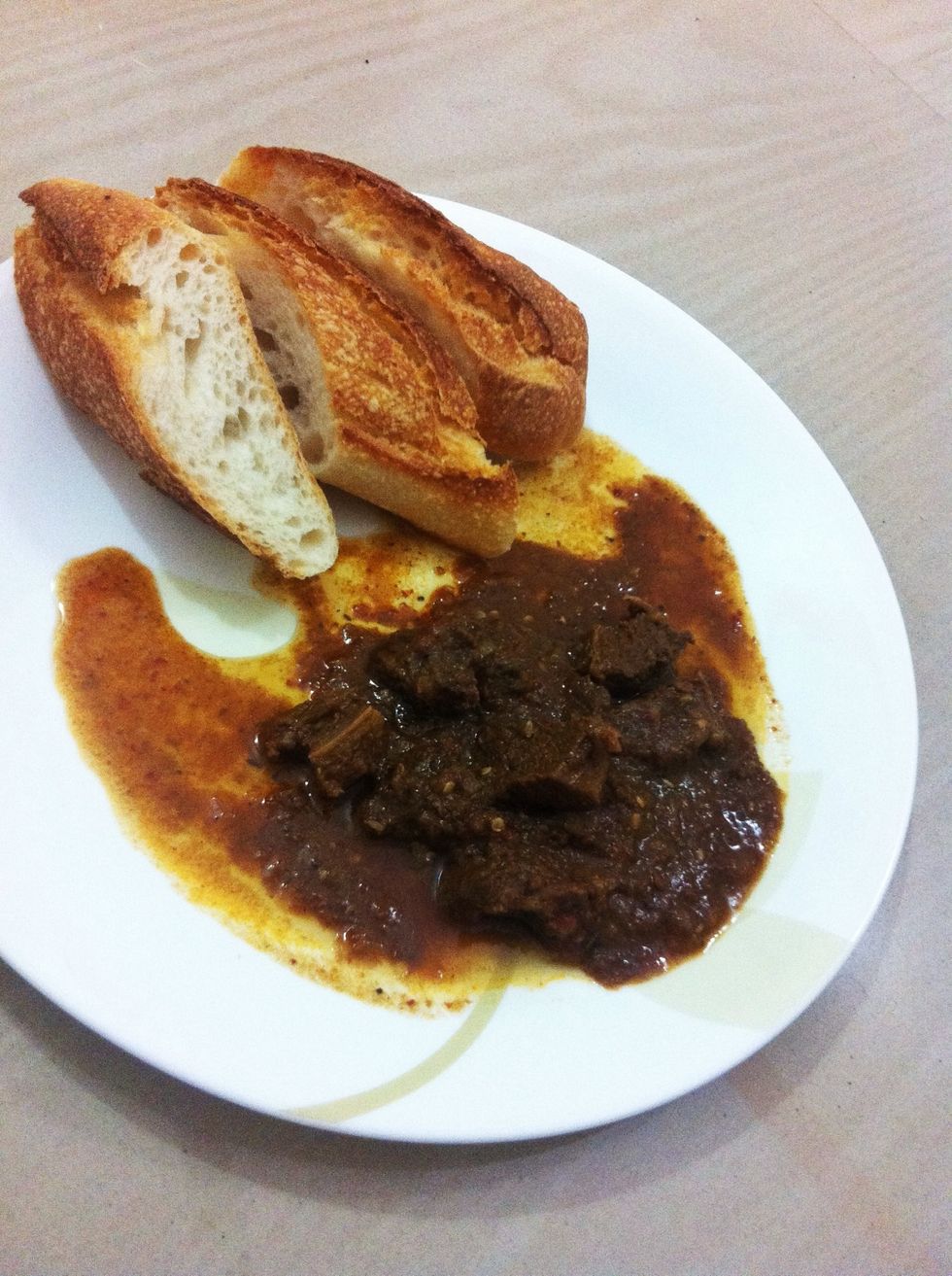 Your dish is ready. Eat after it cools down, it will taste much better. Vindaloo goes well with steamed rice or any bread.