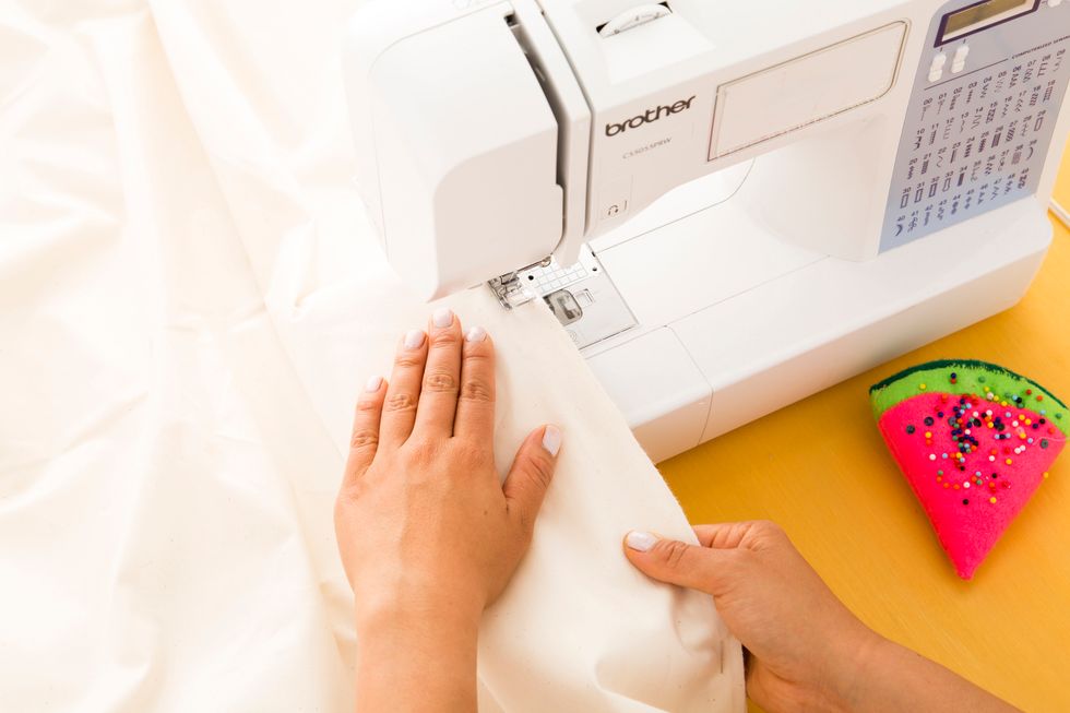 Your fabric should now look similar to a wide V shape. Pin along the folds and sew with the same zigzag stitch.