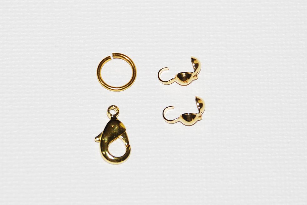 Your "findings" supplies for this project should include 2 clamshell end-caps; 1 jump ring with a slit opening, 1 clasp of any kind that you like (portrayed is a lobster clasp). Any metal is fine.