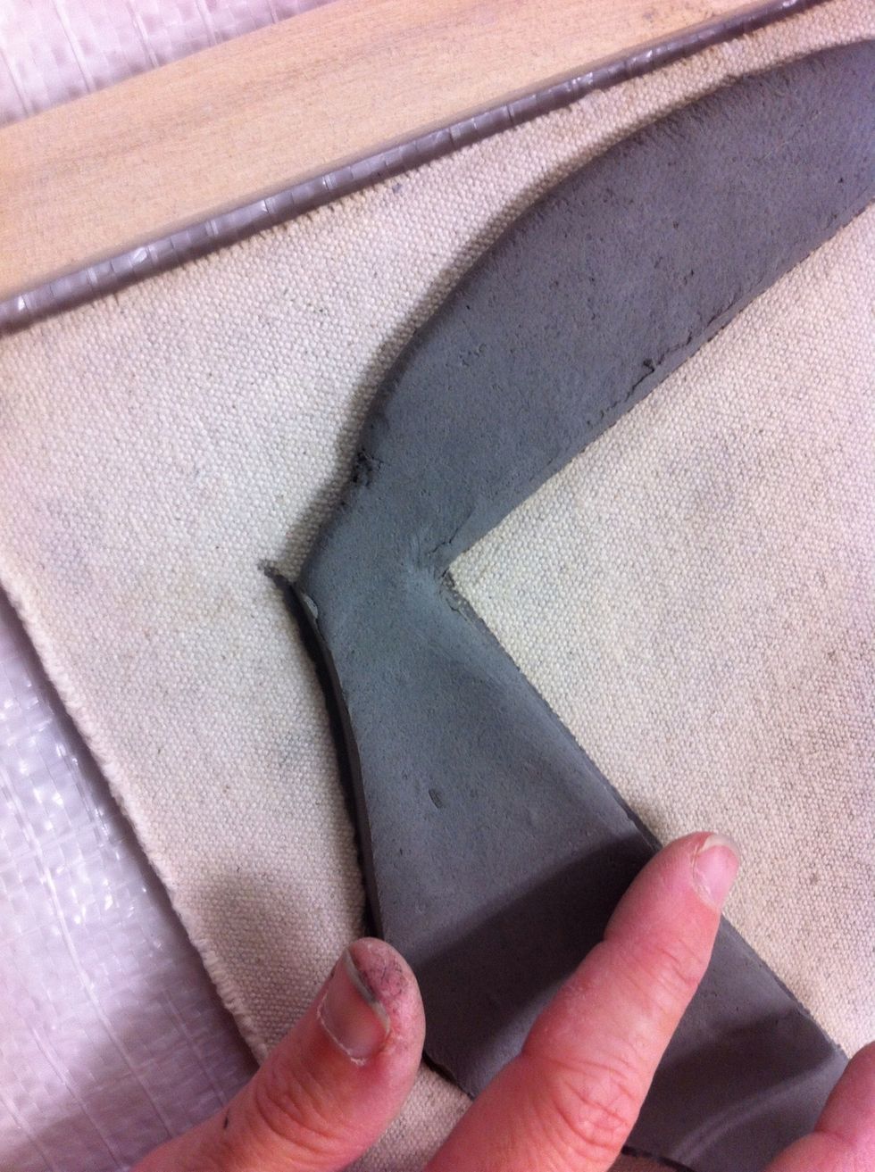 Your finger will smooth the clay just fine!