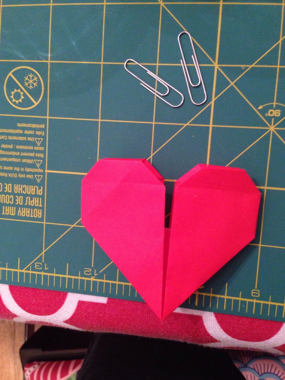 Your heart is folded now. But we still have more work to do. Lift up the top layer of the bottom of the heart to see inside.