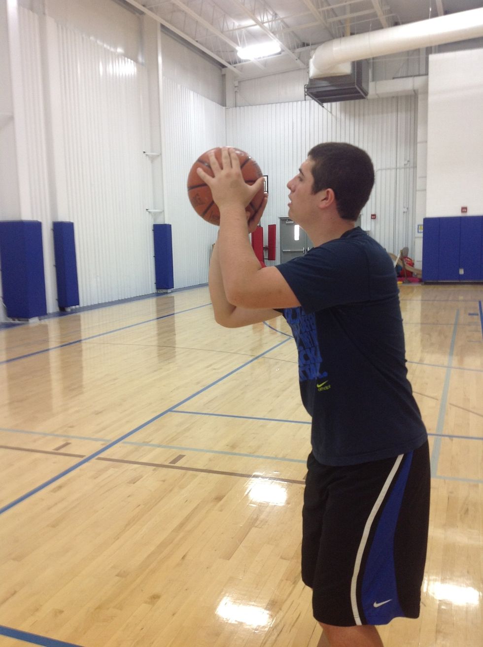 Your left hand should be on the side of the ball.