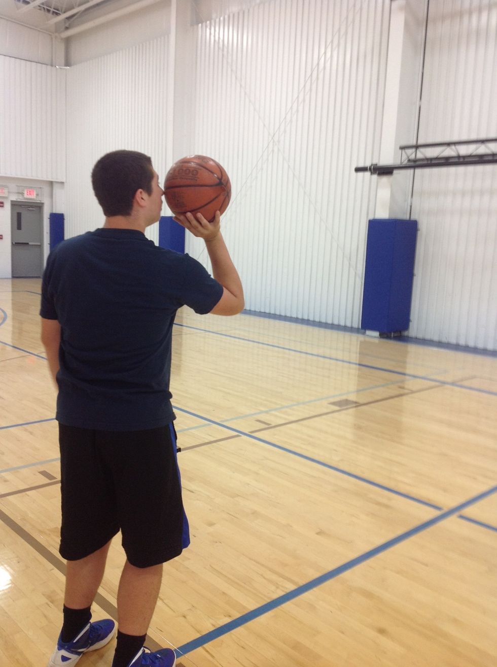 Your right hand should be under the ball.